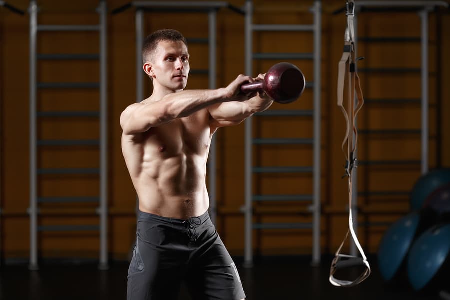 Man using a kettlebell for a kb swing