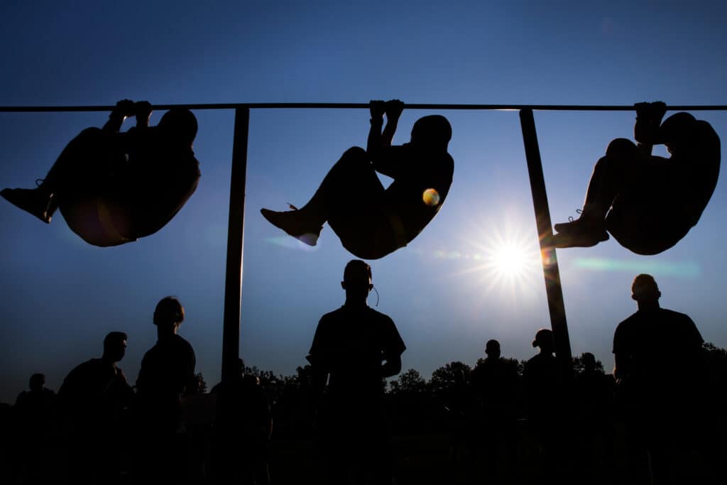 Soldiers doing Leg Tucks for strength of grip, arm, shoulder and trunk muscles.